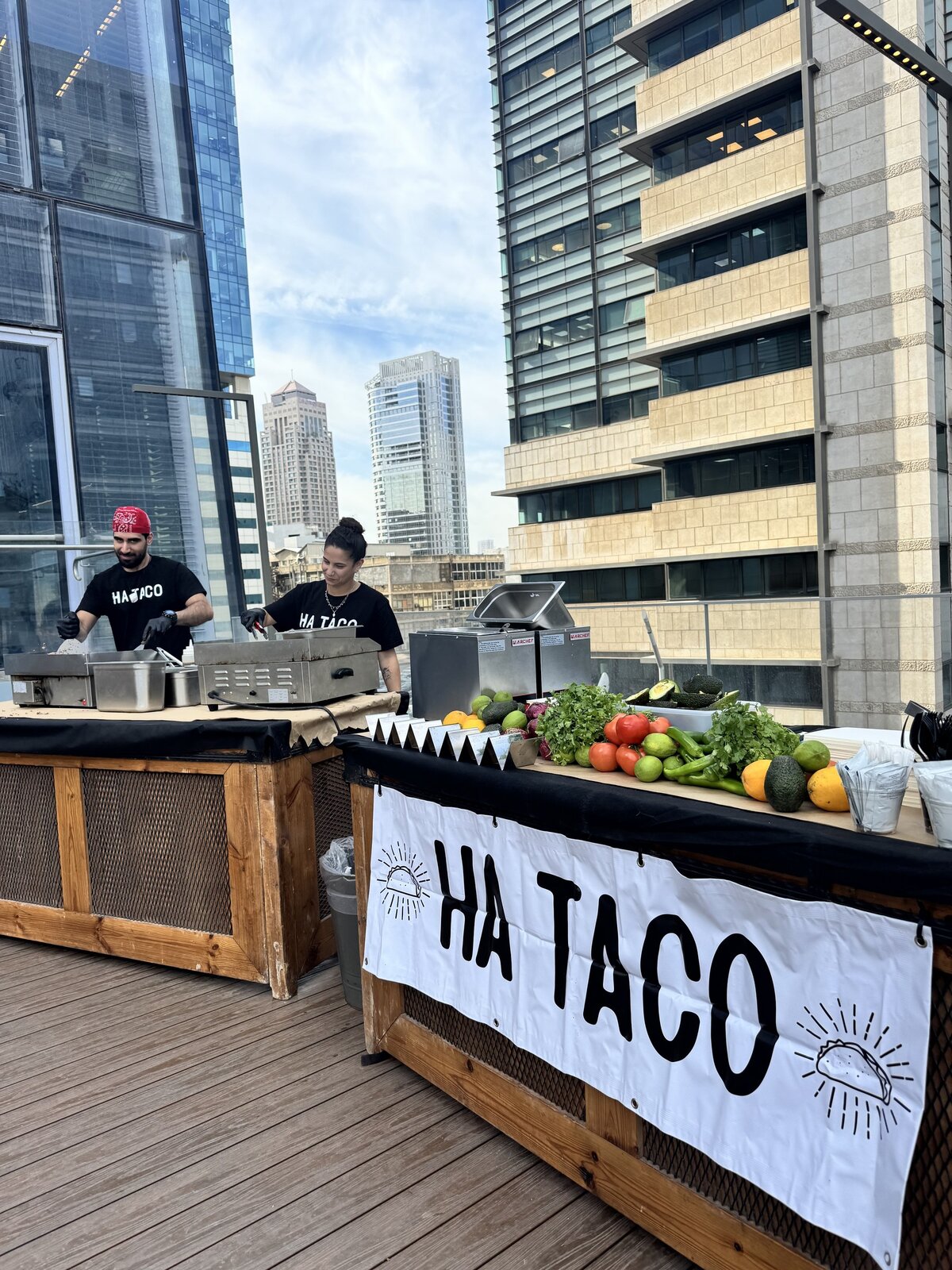 Tel Aviv skyline behind a HA TACO rooftop station