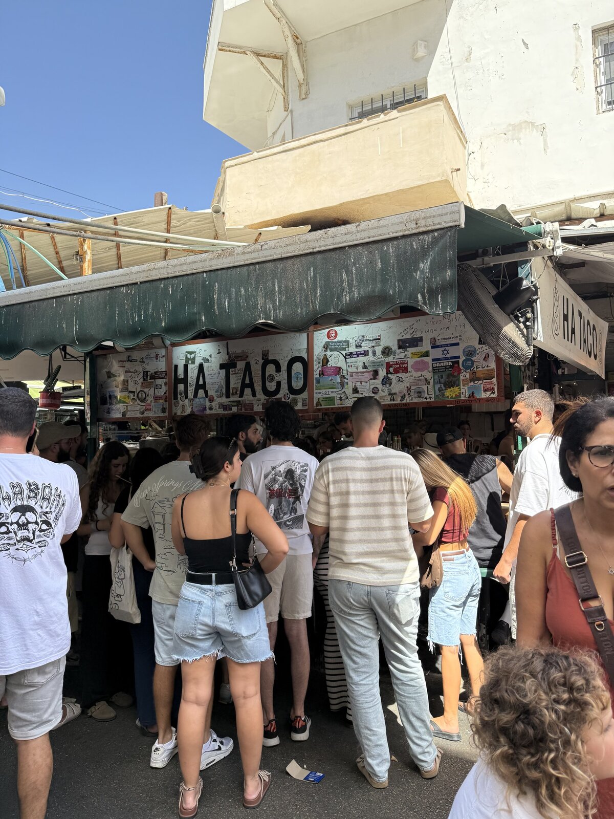 Daytime crowd at the HA TACO stall in the market